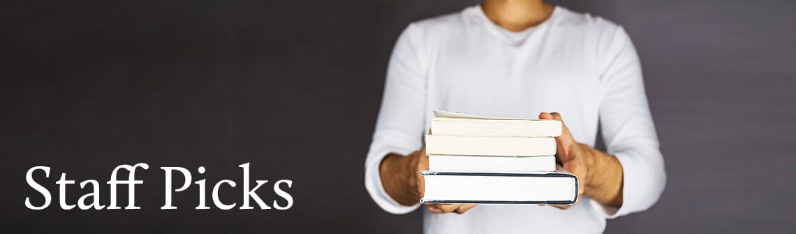 Books holding by man on dark background staff picks